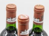 three bottles of wine sitting next to each other on a table