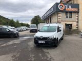 a white van parked in front of a building in a parking lot