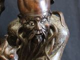 a bronze statue of a man holding a sword