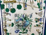a close up of a blue and green scarf with a picture of people on it