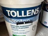 a close up of a bucket of paint sitting on the floor