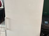 a white refrigerator sitting in the middle of a room