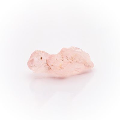 a pink quartz stone on a white background