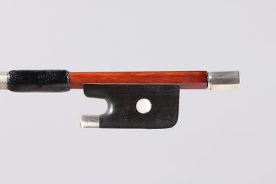 a violin bow with a wooden handle on a white surface