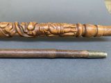 an image of a wooden stick with a carving on it and a wooden stick with a carving on it