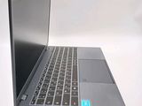 a laptop that is open on a white surface