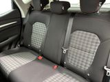 the back seats of a car with a checkered seat cover