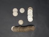 a pile of coins and a roll of coins on a table
