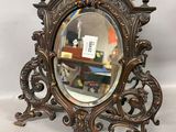 an antique mirror with ornate design on a white background