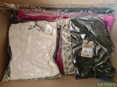 a box of clothing that is packed in plastic bags
