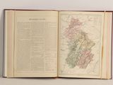 an open book on a table with a map of the united states