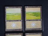 four cards with a picture of a landscape on them on a black background