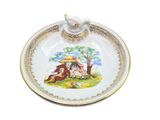 a white plate with a picture of a girl and a horse on it
