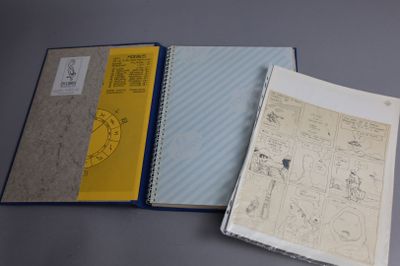 two notebooks with drawings on them sitting on top of a table