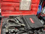 a red tool box with tools in it in a garage