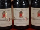 three bottles of wine sitting on top of a table next to each other
