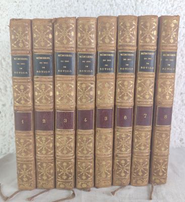 six books are lined up in a row on a table