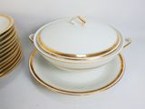 a stack of plates and a bowl with a lid on it