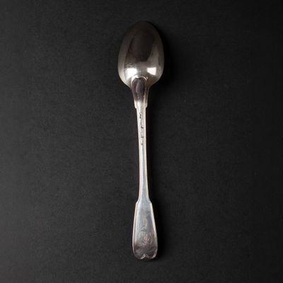 a spoon that is sitting on a black surface