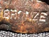 a close up of a piece of metal with writing on it