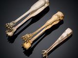 three silverware spoons and a fork on a black surface