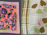 two different types of scarves are displayed on a table