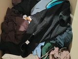 a box full of clothes that is sitting on the floor