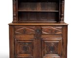 an old wooden cabinet with two doors and a shelf on top