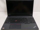 the laptop is open on a white surface with a black keyboard