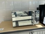 a microwave sitting on top of a cabinet in a kitchen