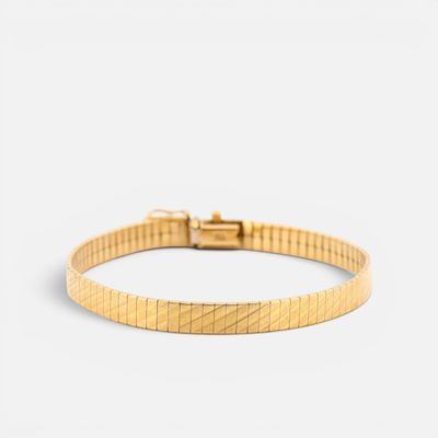 a gold bracelet with a diamond clasp