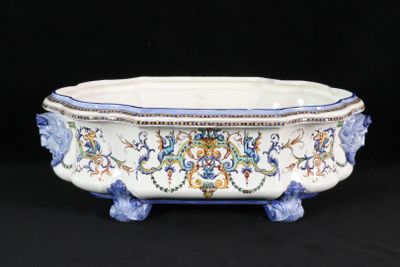 un bol blanc orné de motifs bleus et jaunes
