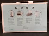 packaging of a boxed smeg coffee maker with instructions on it