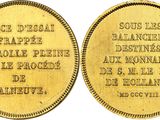 une pièce d'or sur laquelle sont gravés un homme et une femme
