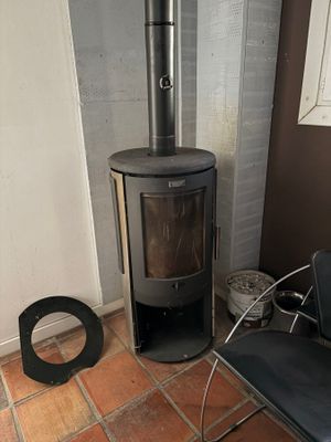 a black chair in front of a stove in a room