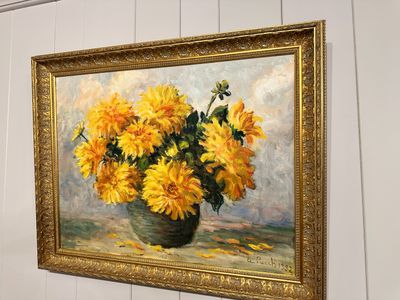 a painting of yellow flowers in a vase hanging on a wall