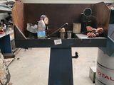 a machine that is sitting in a garage with a lot of stuff on it