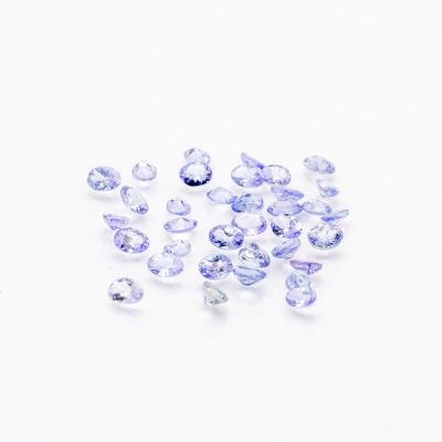 a bunch of blue sapphires on a white surface