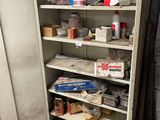 a cabinet with many items in it in a room