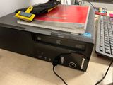 a computer sitting on top of a desk next to a keyboard