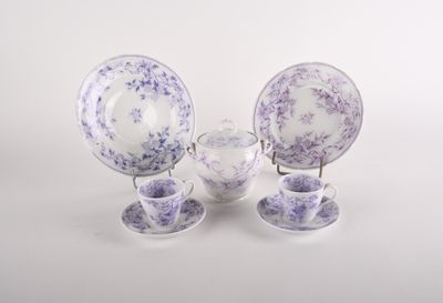 purple and white porcelain dishes and cups and saucers
