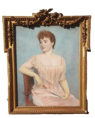 portrait of a woman in a pink dress sitting on a red chair