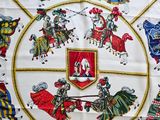 a picture of a table cloth with a picture of knights on it