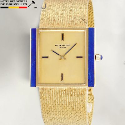an image of a gold watch with a blue band on a white background