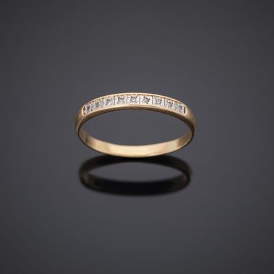 a yellow gold wedding band with princess cut diamonds