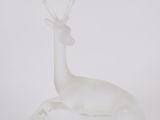 an image of a glass sculpture of a deer on a table