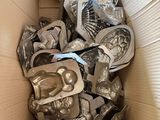 a cardboard box full of silver items in it
