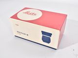 a red box with a blue lid on a white surface
