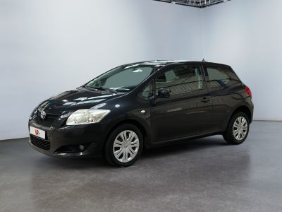 a black toyota auris is parked in a white room