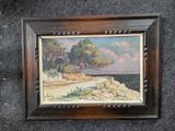 tableau représentant une scène de plage avec des arbres et des rochers, dans un cadre en bois